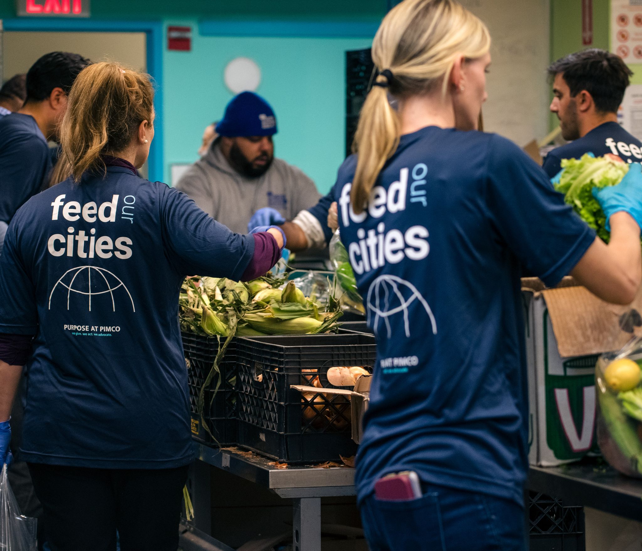 People packing crates with food