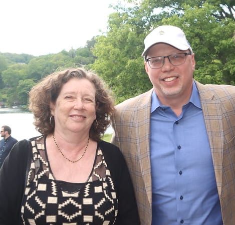 Three people at a golf tournament