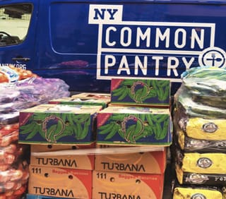 Boxes of food in front of NYCP blue van