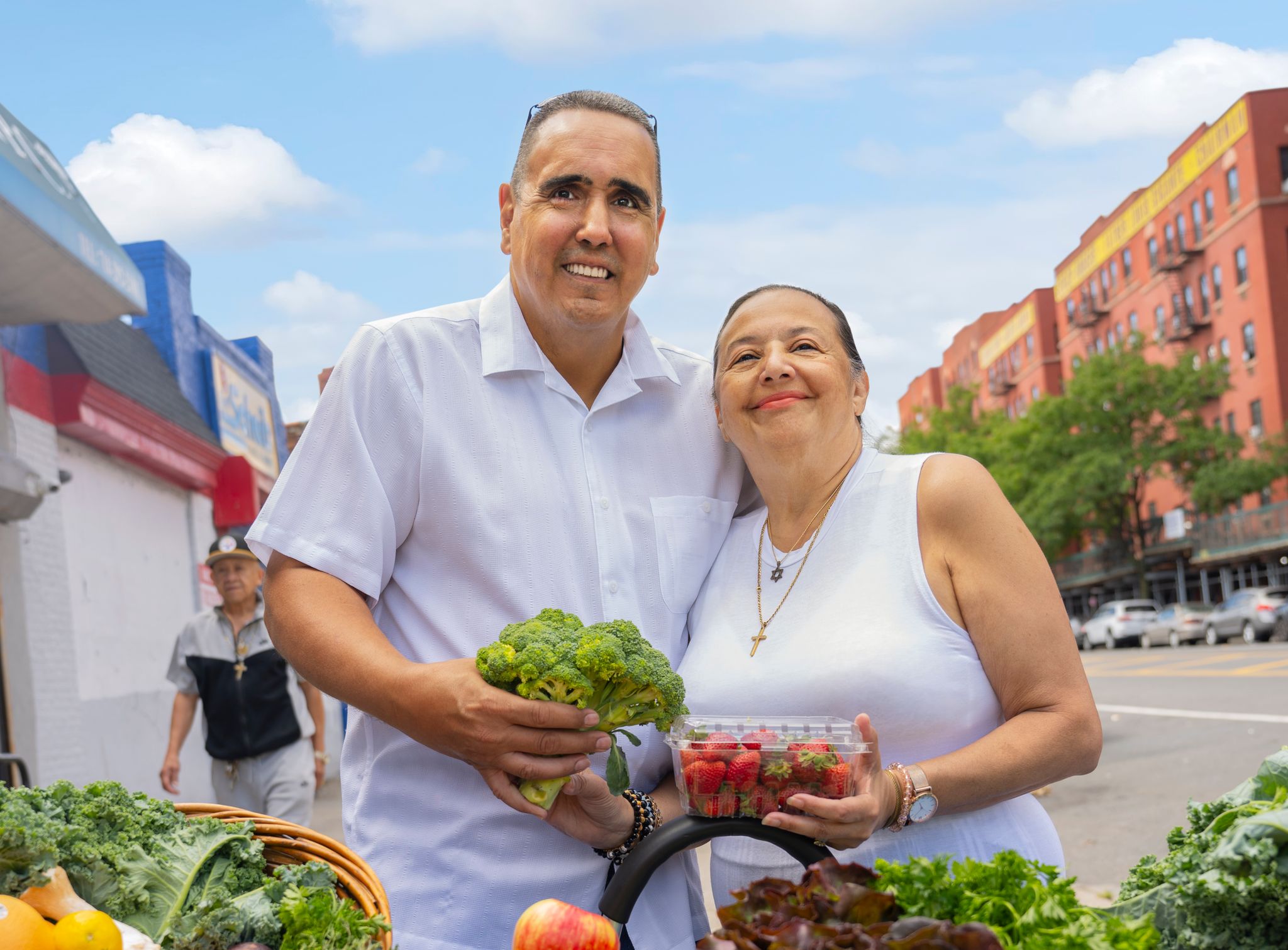 Couple in front of produce