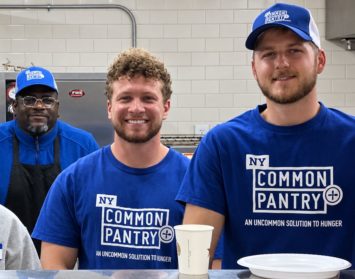 Four people in the kitchen with NYCP shirts