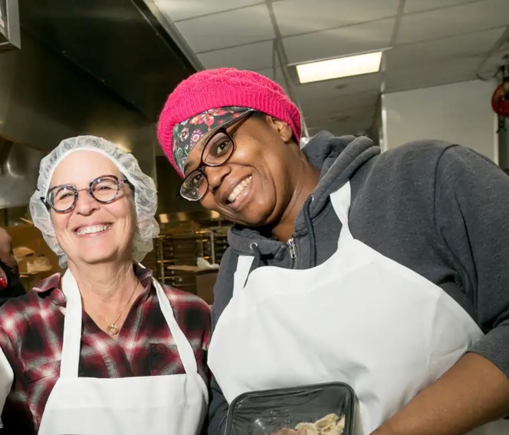 Two women working in the kitchen.