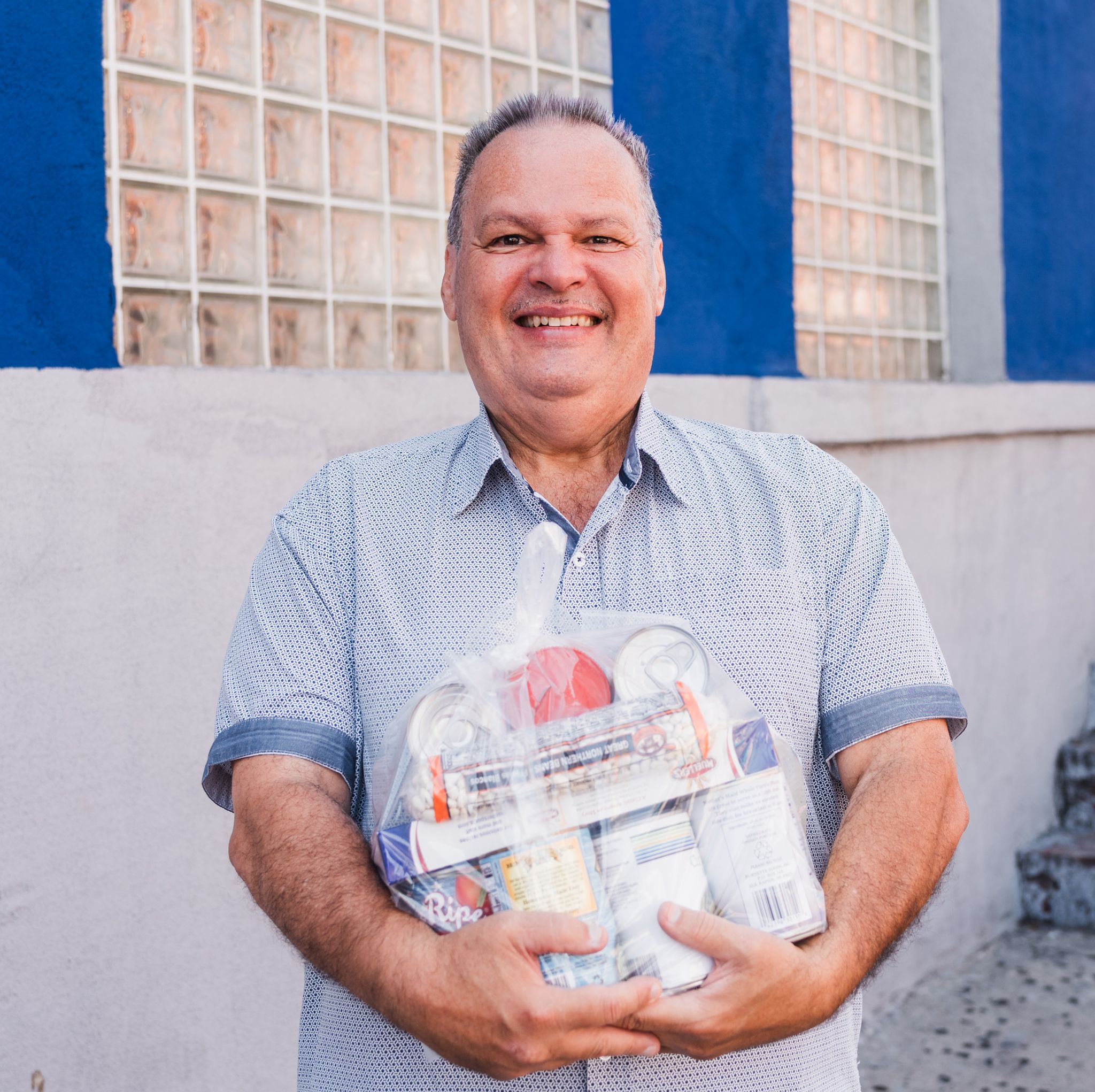 Man holding cans of food