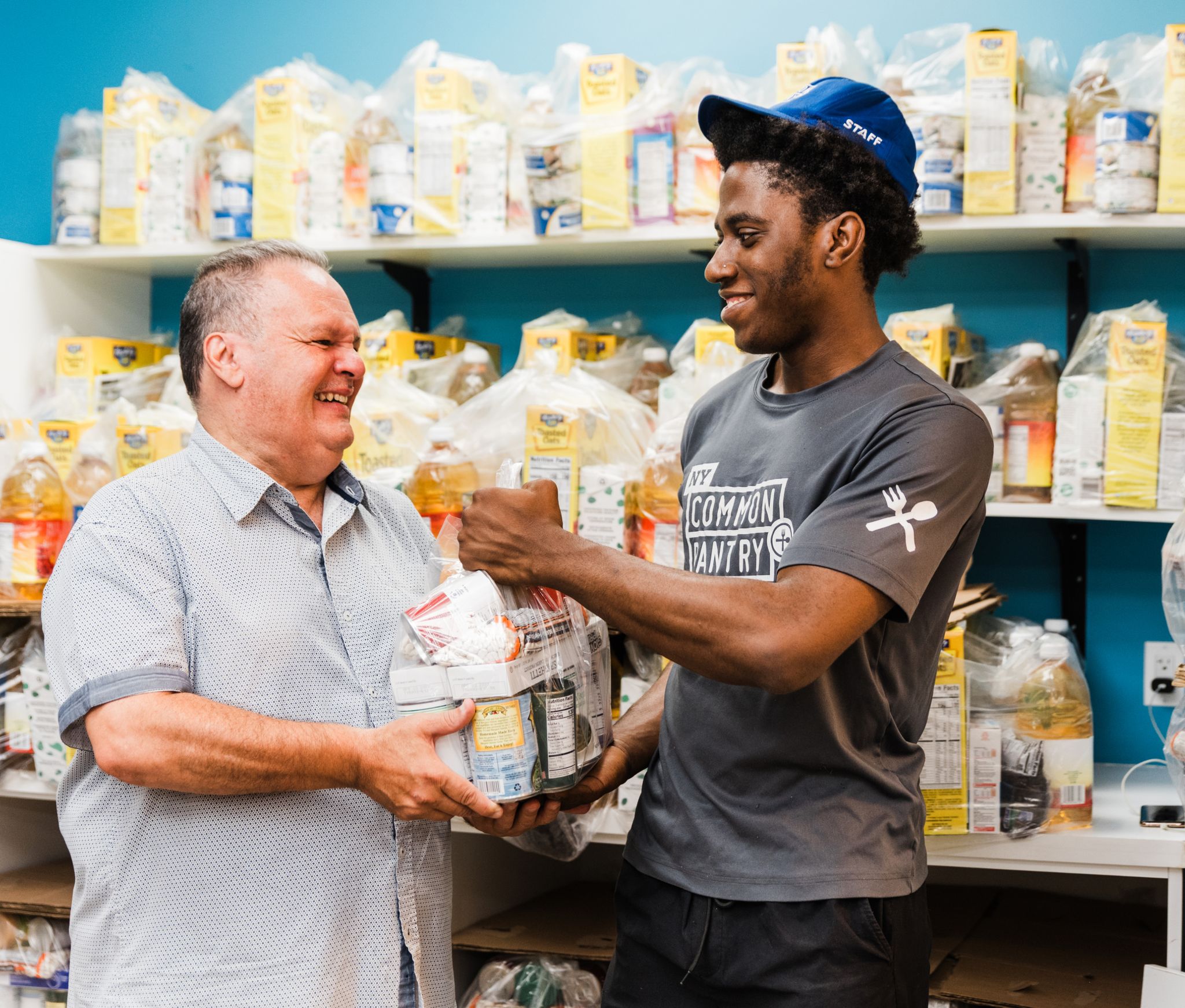 Staff member giving groceries