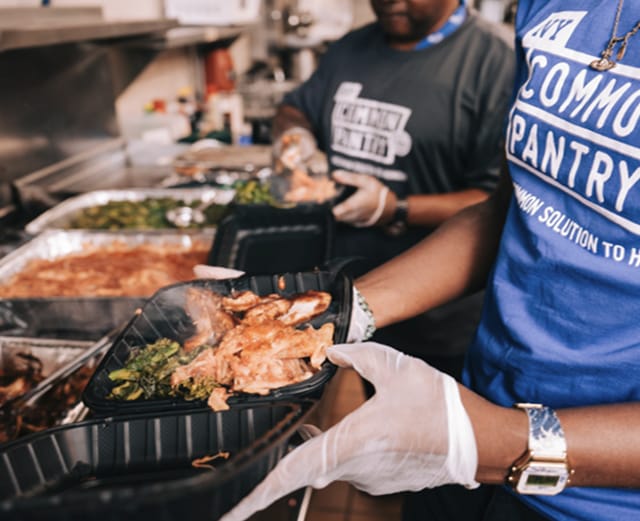 Volunteer holding cooked food