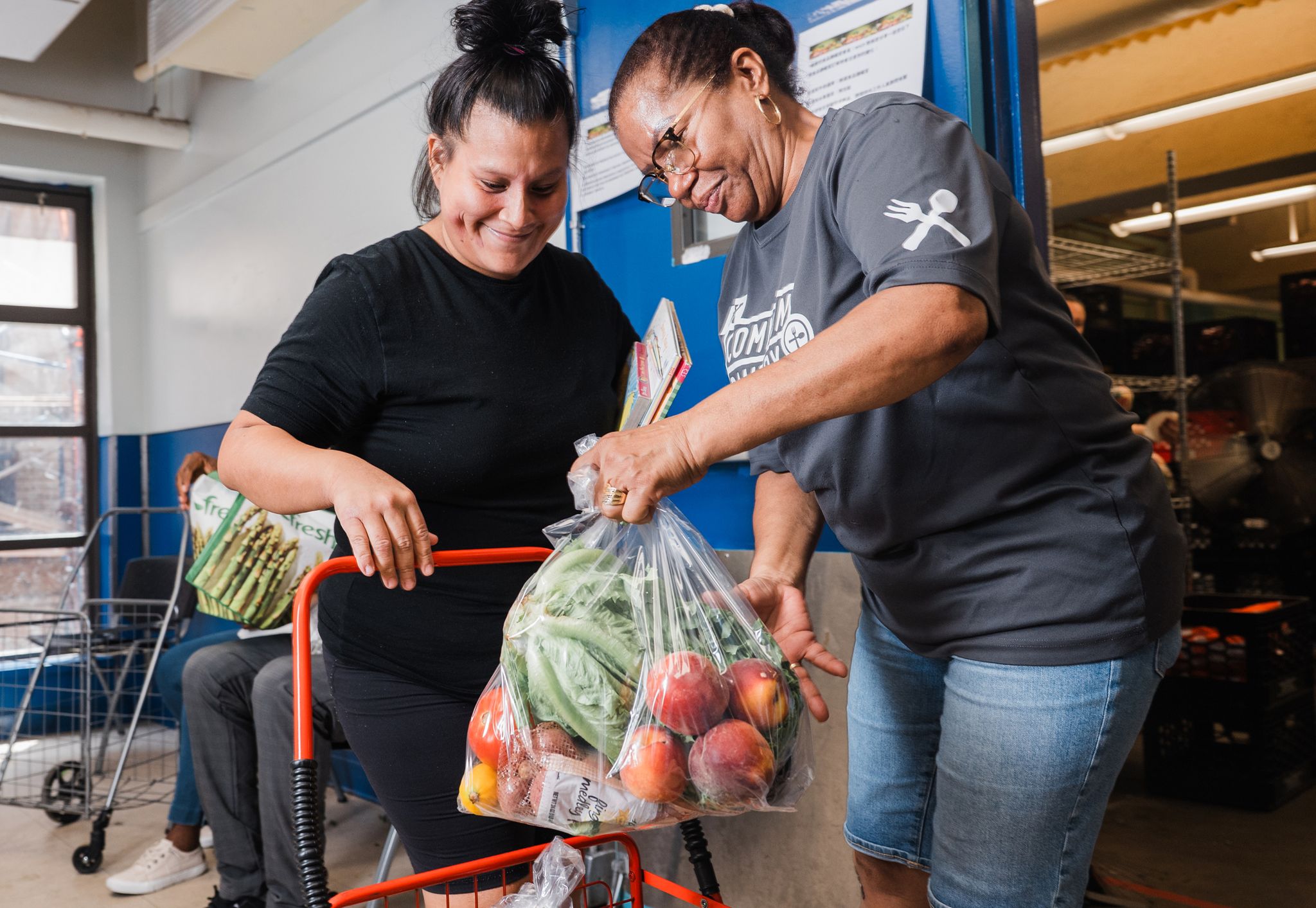 Woman placing groceries in cart